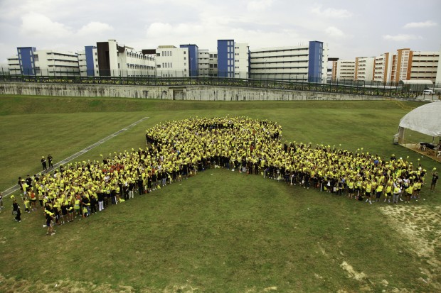 The formation of Singaporeís largest giant human yellow ribbon in Singapore to symbolise the concerted effort in supporting the rehabilitation and reintegration of ex-offenders.