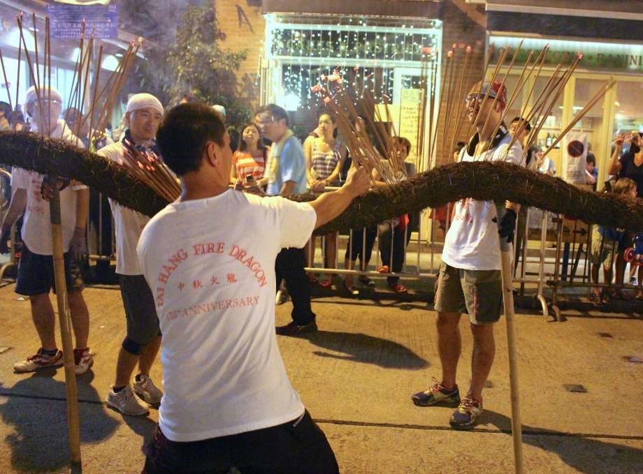 Inserting Incense sticks into Tai Hang Fire Dragon Hong Kong - AspirantSG