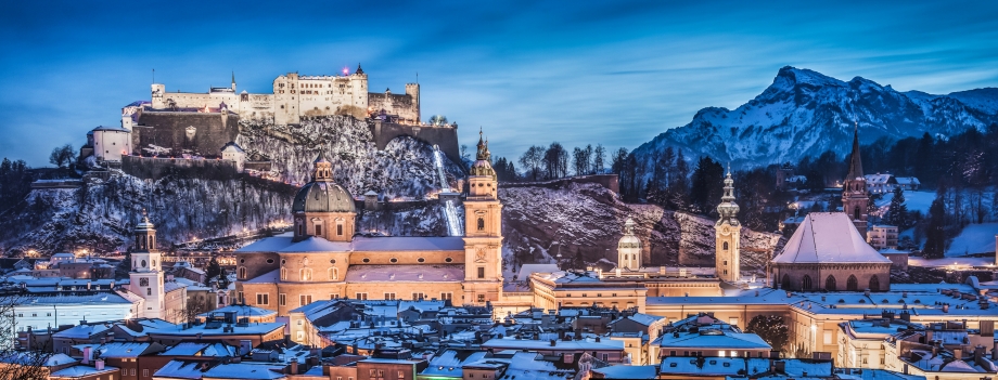 Panoramic view of the historic city of Salzburg with Hohensalzburg Fortress in winter at blue hour, Salzburger Land, Austria - AspirantSG